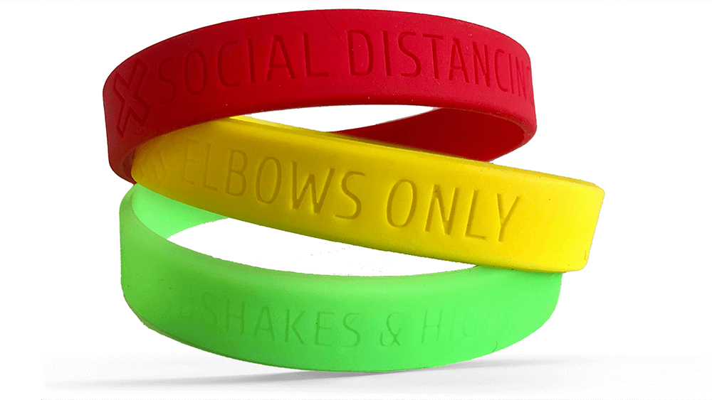 Photo of the 3 social distancing wristbands. Red: I am socially distancing. Yellow: I am being cautious. Green: I'm comfortable with being approached from shorter distances.