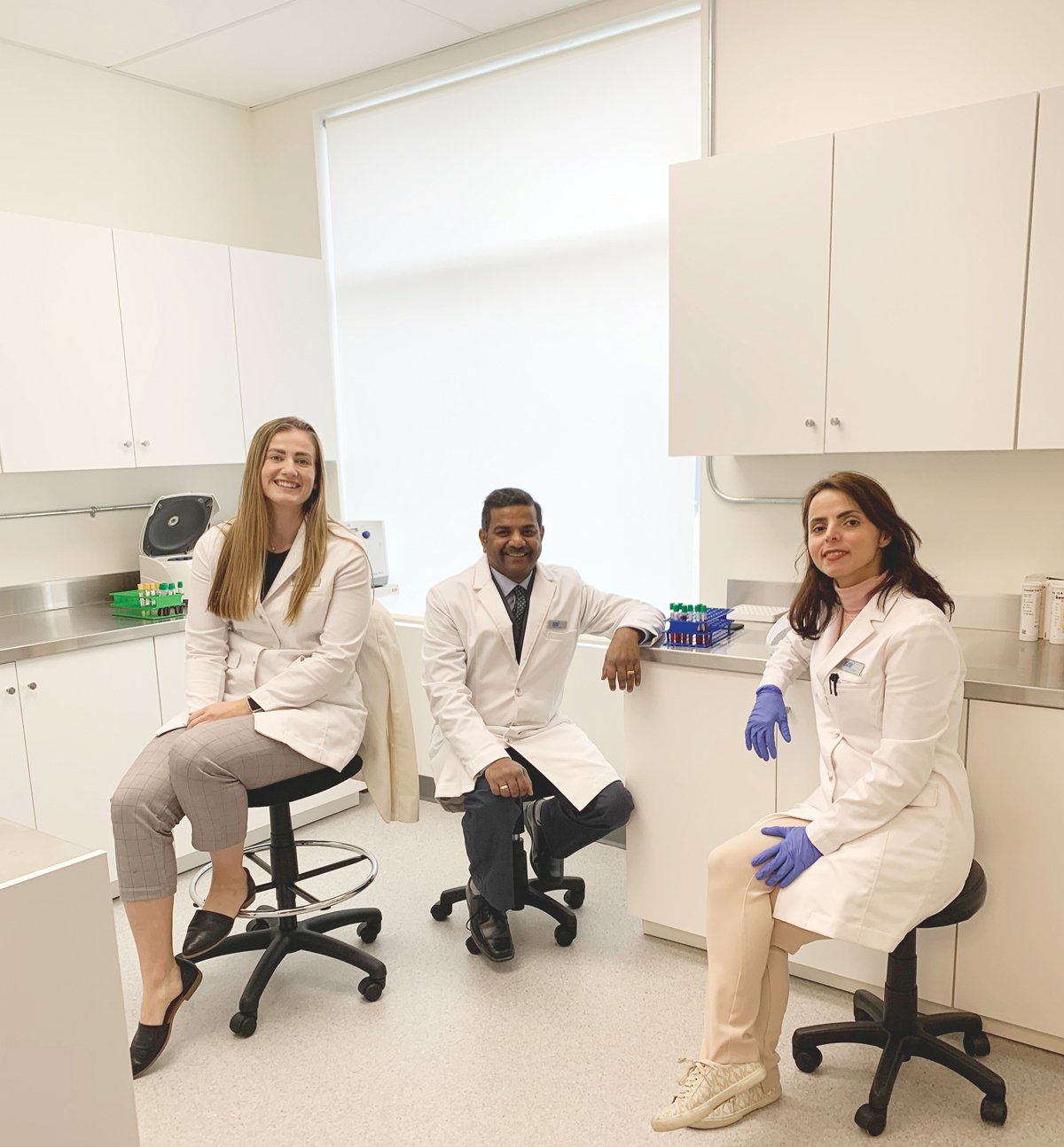 Photograph of Madyson, Vanu and Maryam in one of our clinic laboratory rooms.