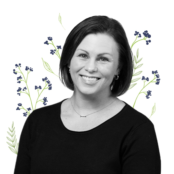 Photograph of Erin Taraborrelli, Director, Regulatory Affairs with little purple flowers around her