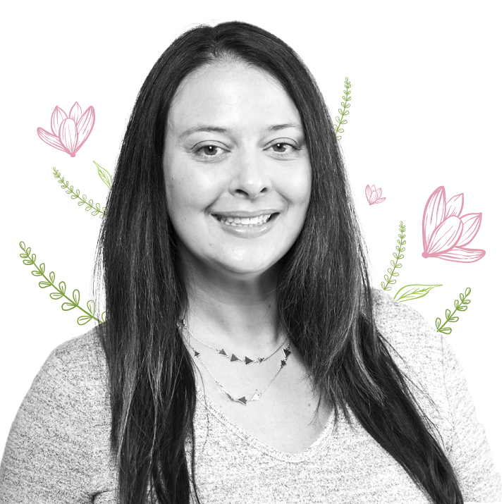 Photograph of Krista Coventry, Senior Director, Clinical Affairs and Regulatory Strategy surrounded by pink flowers