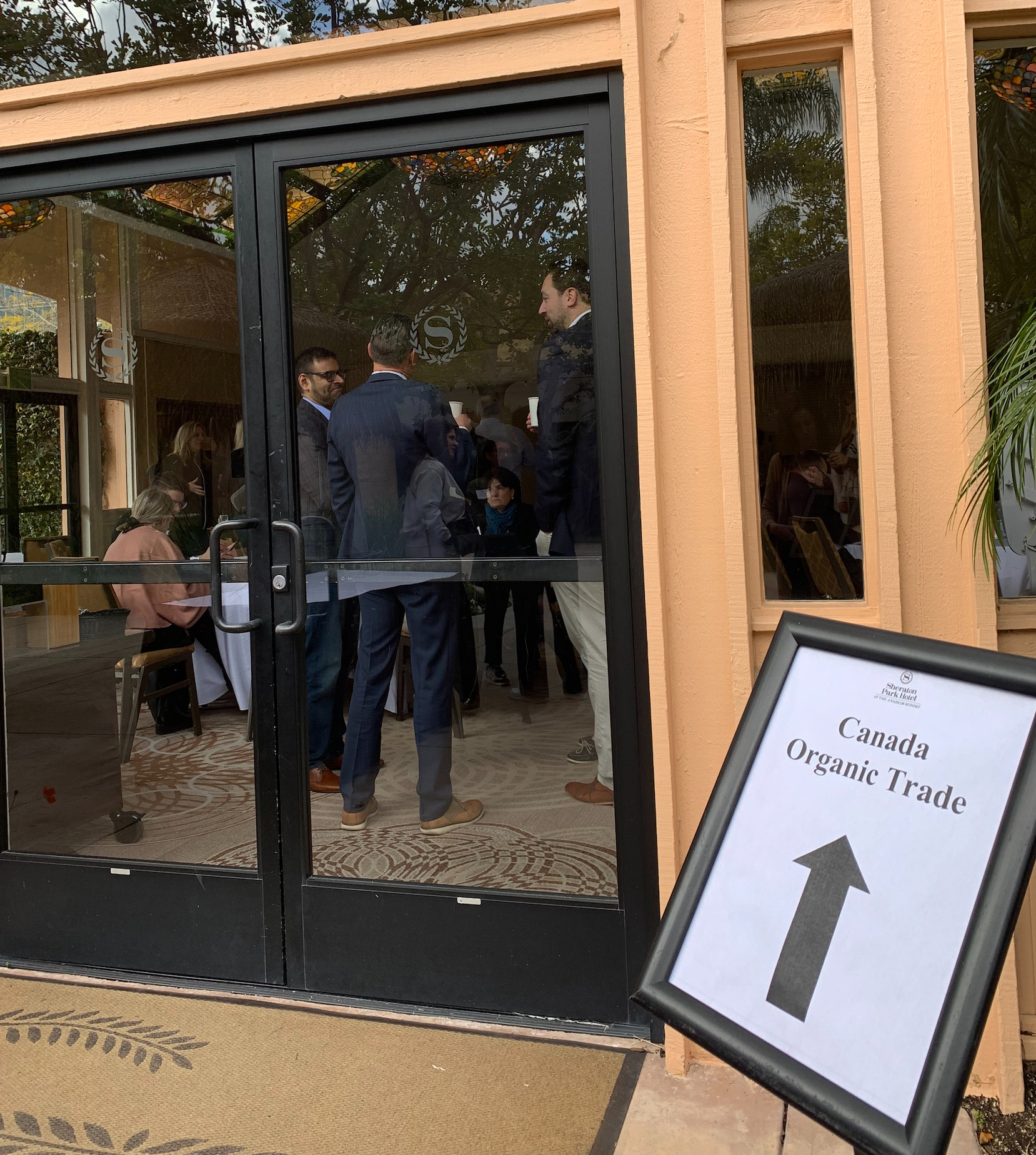 Photograph of the event entrance at the Sheraton Park Hotel - with Canada Organic Trade sign and arrow