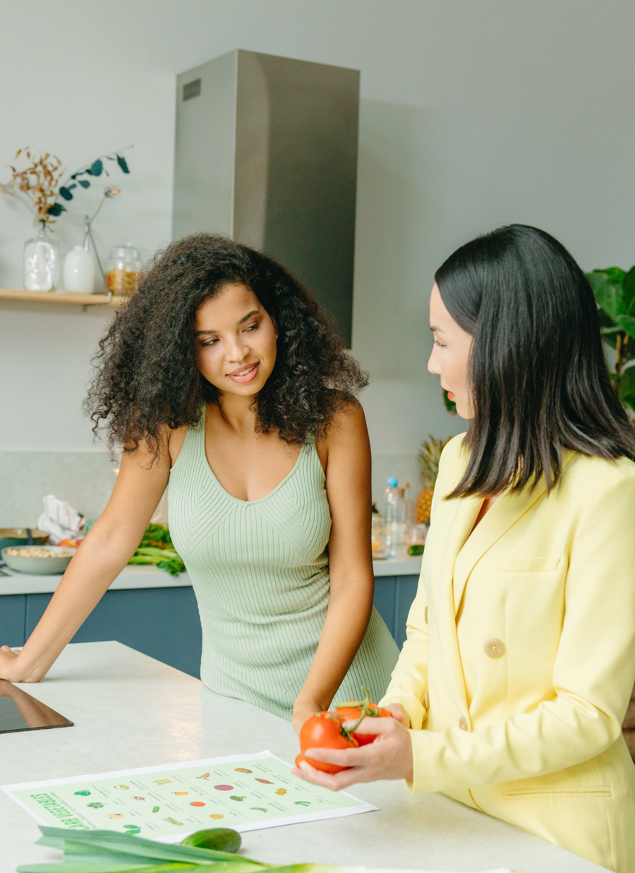 Photograph of a dietitian discussing nutrition with a woman in a kitchen.