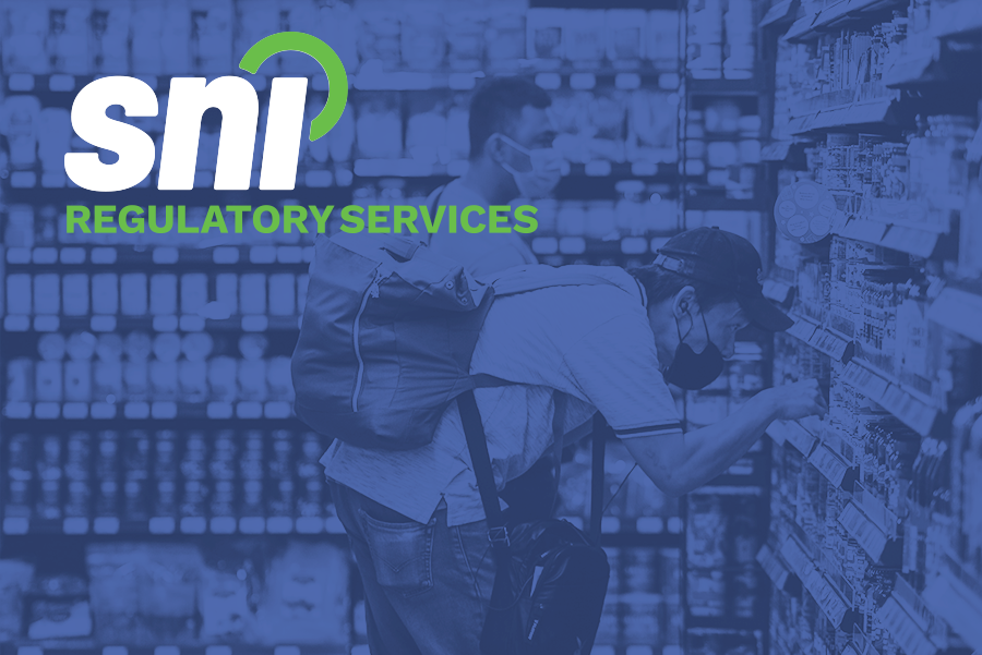 Photograph of a fella shopping and reading labels in a retail grocery store.