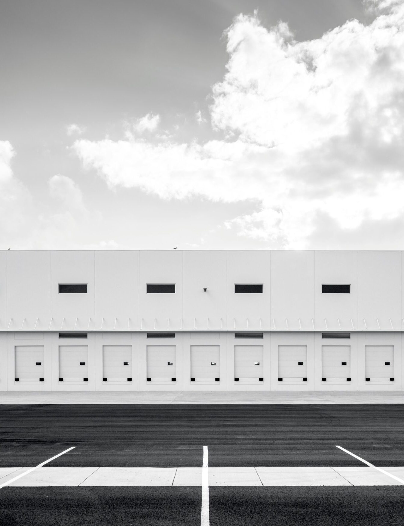 Black and white photograph of a warehouse loading dock