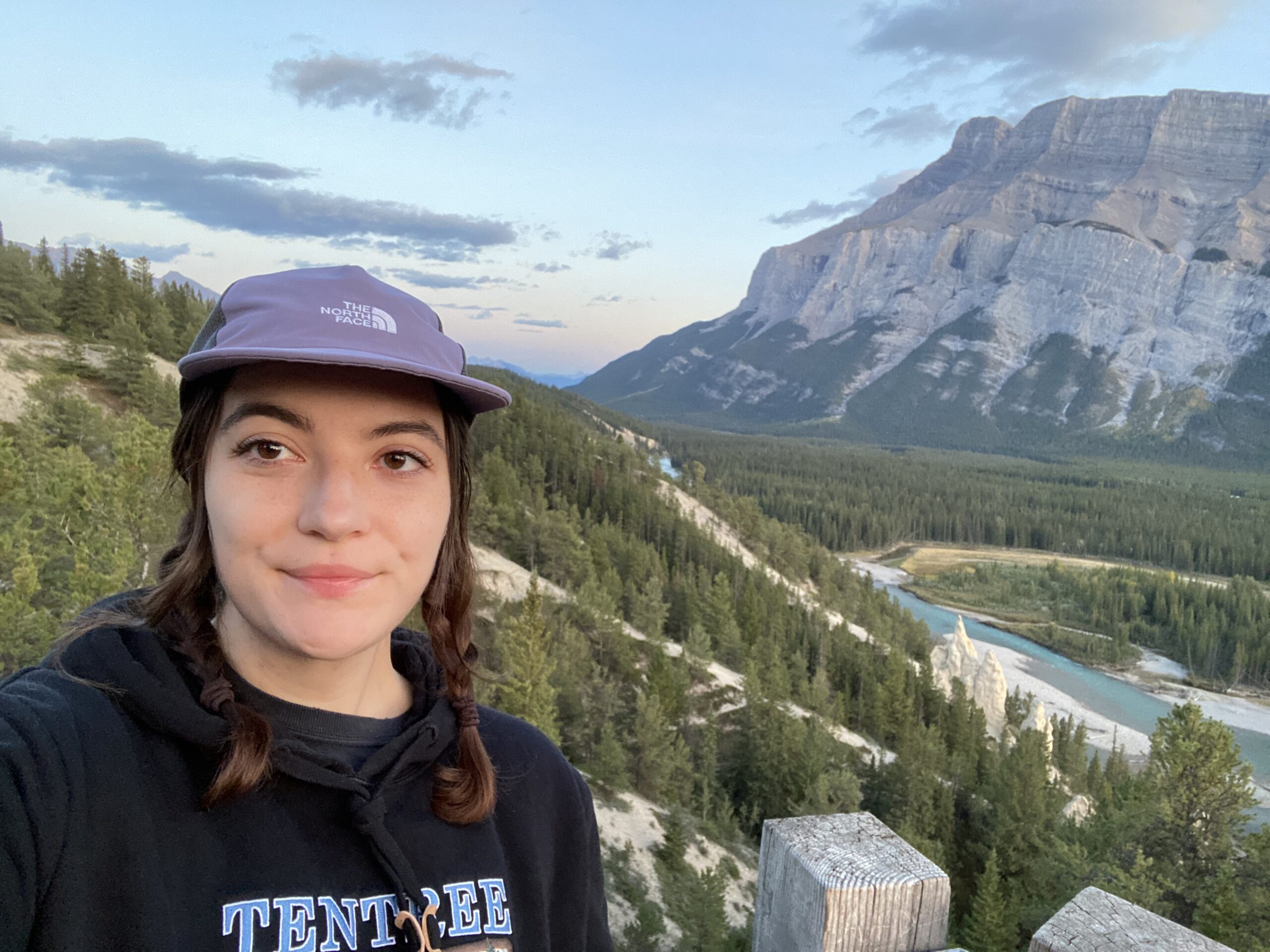 Jada Zazulinski, Graphic Designer, in front of scenic background