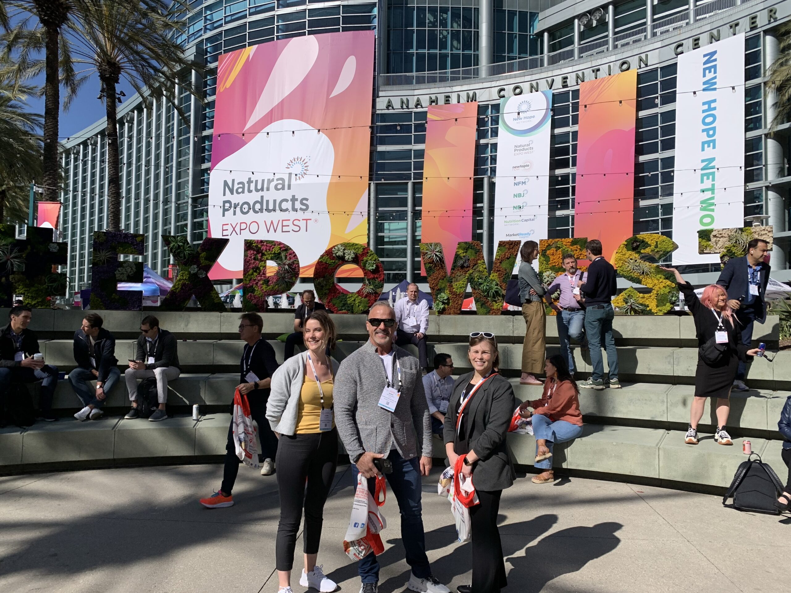 Bernie Desgagnes, Leanne Lutomsky, Erin Taraborrelli in front of the Expo West Convention Center