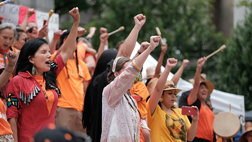 Vancouver, BC, Canada - July 1, 2021: Vocalists perform at a "Cancel Canada Day" rally in reflection of the Canadian Residential School System. SOURCE: Government of Canada