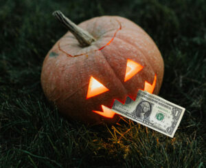 A jack o lantern eating a dollar bill