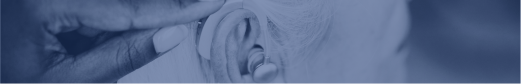 Photograph of person adjusting a hearing aid with blue overlay